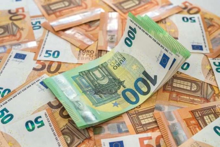 new clean beautiful banknotes of 50 euros are laid out and on them are banknotes of 100 euros on the table. Wealth concept. Money concept